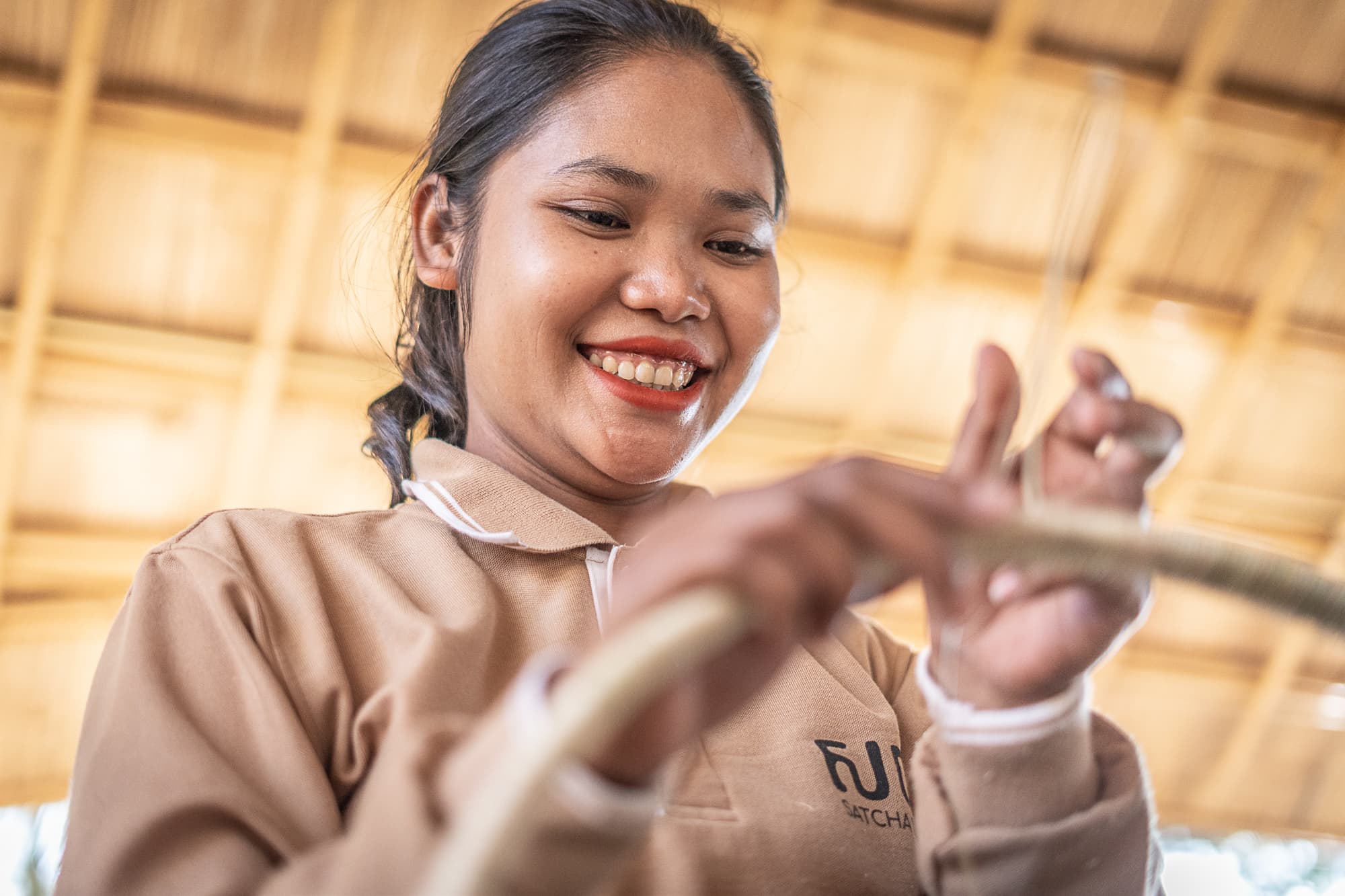 Hands shaping a handcrafted piece in a Satcha workshop.