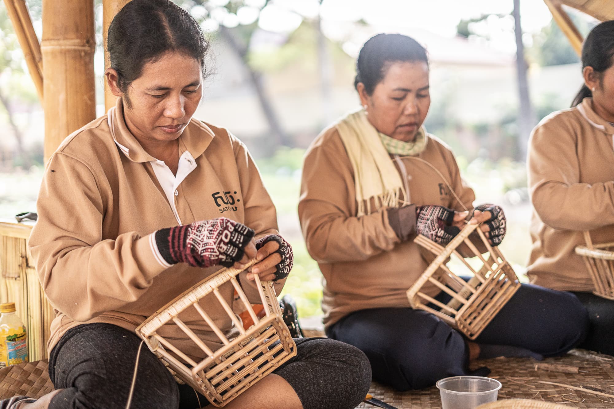 Close work on a craft object inside the bamboo workshops.